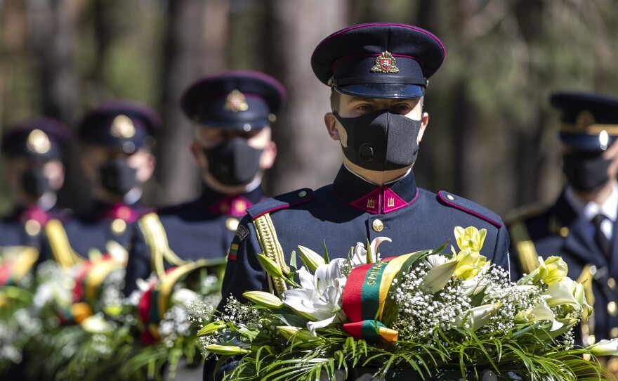 Members of the Lithuanian honor guard mark the 75th anniversary of the end of World War II in Europe at a memorial Friday in Vilnius.