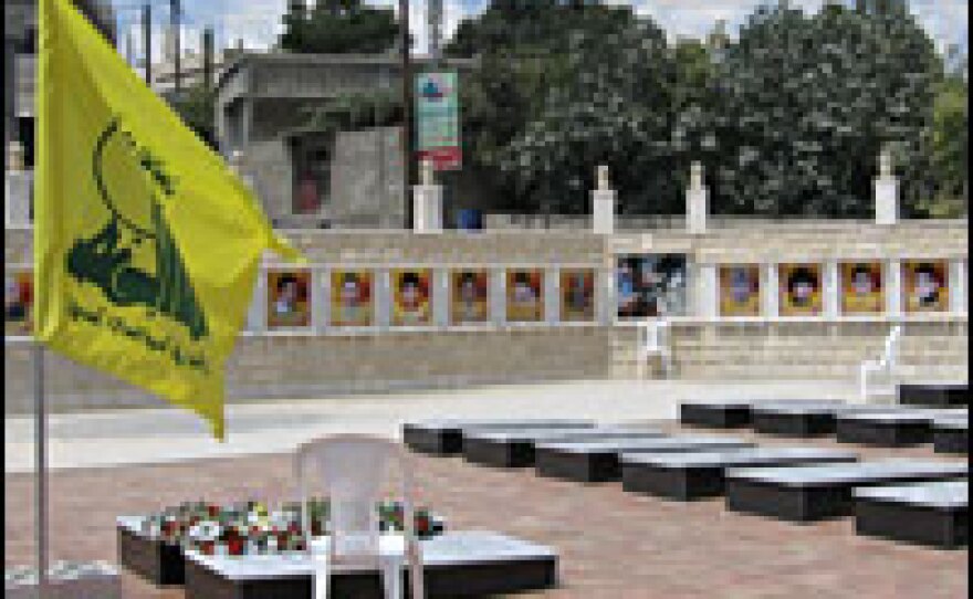 A Hezbollah flag flies at the memorial built for the 27 civilian victims of an Israeli airstrike in the southern Lebanese village of Qana.