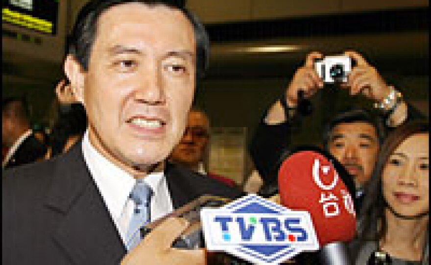 Ma Ying-jeou, mayor of Taipei and chairman of Taiwan's main opposition Kuomintang, talks to members of the press after arriving at Narita Airport in suburban Tokyo, July 10.
