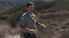Matt Sanford, senior ranger of Mission Trails Park, stands in front of a piece of open space that will make San Diego's biggest park even bigger. 