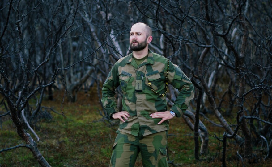 Capt. Sigurd Harsheim stands at the base of the mountains where the observation post sits. Russia is steadily building up military bases and its nuclear arsenal in the Arctic.