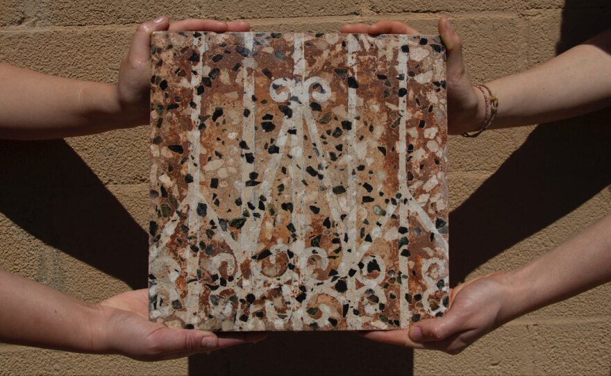 "Untitled, Porton," is a 2022 carved terrazzo tile by Jezabeth Roca Gonzalez. The tile belonged to their aunt and family for 30 years; the artist rendered the design of a gate (porton) from their family's house across the tile.