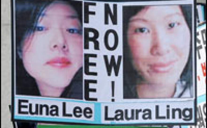 A south Korean conservative activist holds pictures of U.S. journalists Euna Lee (left) and Laura Ling during a June 4 rally denouncing North Korea's detention of the journalists.