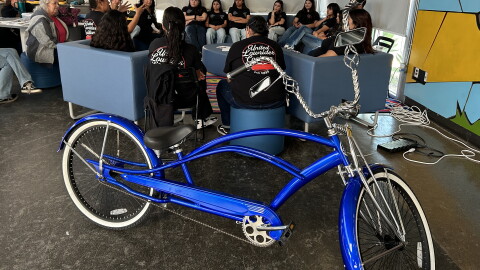 Mentors with the United Lowrider Youth Leadership Bike Club speak to students in the program on April, 28, 2026.