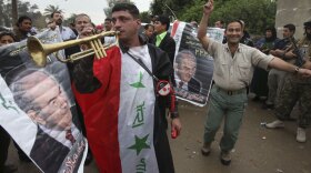 Supporters of former Iraqi Prime Minister Ayad Allawi celebrate in Baghdad in March, after election results showed Allawi edging out current Prime Minister Nouri al-Maliki. But Iraq's neighbors are nervous about instability in Iraq since the election, and some are quietly worried about the display of democracy in their backyard.