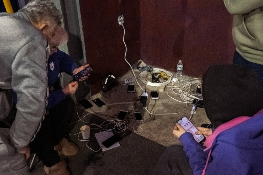 Ukrainian war refugees eagerly charge there cell phones at Tijuana's "Unidad Deportiva Benito Juárez" looking for news from the war, April 4, 2022.<br/>