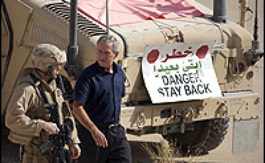 President Bush chats with a Marine. Monday's visit to Anbar province comes ahead of a crucial report to Congress on U.S. strategy in the war-torn nation.