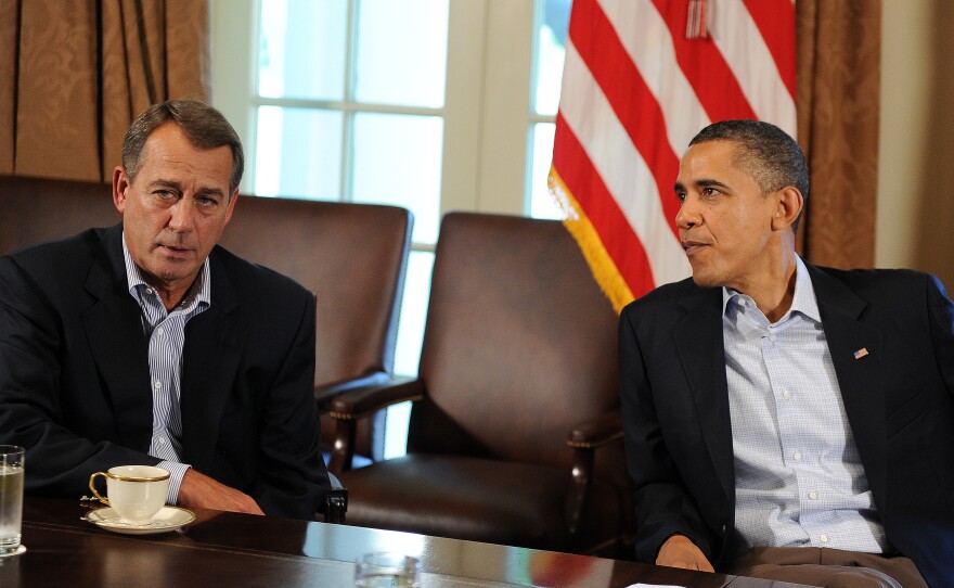 Then-President Obama speaks with Then-House Speaker John Boehner during a meeting about the debt ceiling at the White House on July 23, 2011 in Washington, D.C. S&P downgraded the U.S. rating for the first time days after both leaders clinched a deal to avoid a debt default.