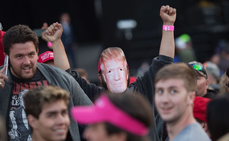 A supporter of Republican presidential candidate Donald Trump wears a mask during his Thursday campaign rally at the Orange County Fair and Event Center in Costa Mesa, California.