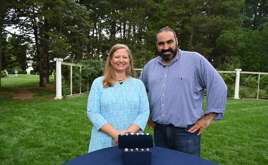 Simeon Lipman (right) appraises UConn Huskies NCAA championship rings, in Middletown, Conn.