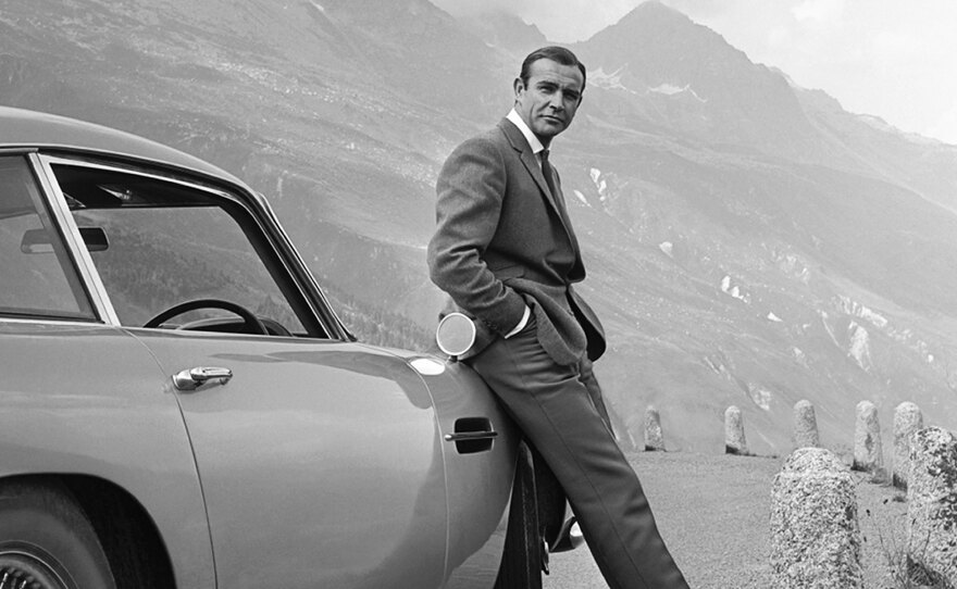 Sean Connery and Bond's famed Aston Martin DB5, during the filming of <em>Goldfinger.</em>