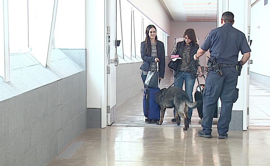 Two passengers walk out of the Cross Border Xpress, Dec. 9, 2015. 