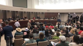 People gather inside the Escondido City Council chambers as the council weighs voting to support the Trump administration's lawsuit against California's sanctuary state laws, April 4, 2018. 