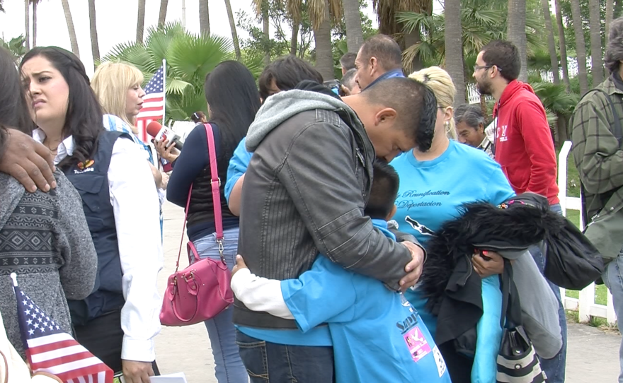 Victor Ledezma comforts his nine-year-old epileptic son in Tijuana, May 8, 2015.