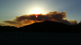 The sun is shown through thick smoke along Interstate 15 near Rancho Bernardo, May 14, 2014.