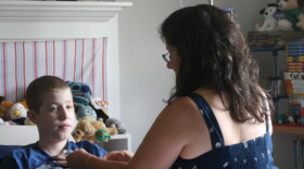 Laura Zakhar connects her son, Kevin, 15, to the "feedbag" that contains his nutrition. Lately, Zakhar has had trouble getting the calcium solution Kevin needs, in part because hospitals have been reserving limited supplies for patients who need it even more desperately than he does.