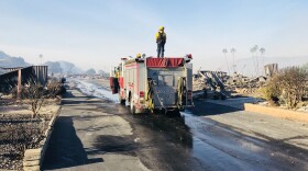 A fire truck passes through a neighborhood burned down by the Lilac Fire at Rancho Monserate Country Club off U.S. Route 395, Dec. 8, 2017.