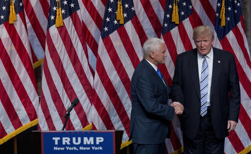 Donald Trump shakes hands with the man he picked to be his running mate, Gov. Mike Pence of Indiana, on Saturday in New York.