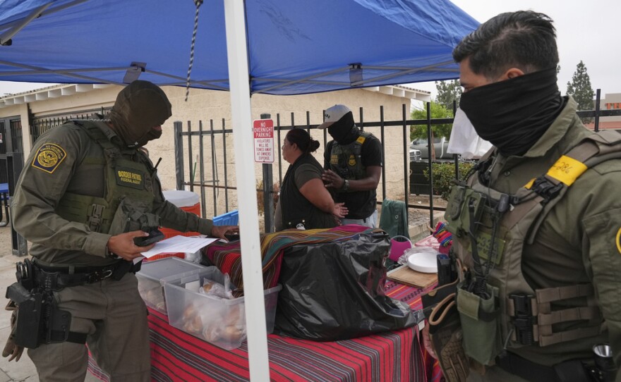 A woman is detained by U.S. Border Patrol agents outside a Home Depot Friday, Aug. 15, 2025, in Los Angeles.