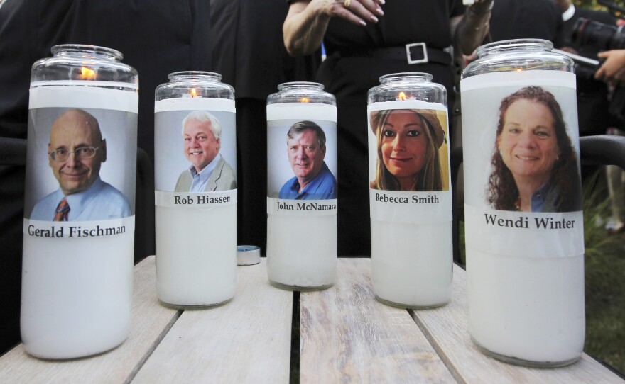 Five employees of the Capital Gazette newspaper are honored across the street from where the the newsroom where they were killed in Annapolis, Md.
