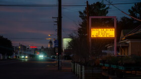 Across the Big Bend, anti-wall signs, flyers and messages have popped up in homes and businesses, like this liquor store in Marfa, Texas.