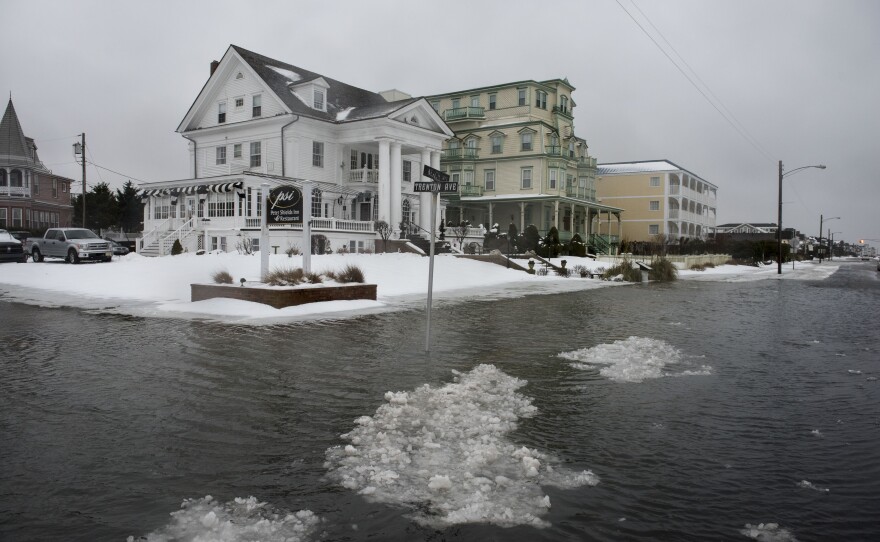 Ice forms as the winter storm mixed with high tide causes flooding on Beach Avenue on Jan. 23 in Cape May, N.J.