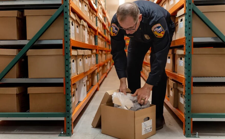 Stewart McMorrow, staff chief of wildfire resilience for Cal Fire, opens a box of seeds in the seed bank at the Lewis A. Moran Reforestation Center in Davis on July 15, 2026.