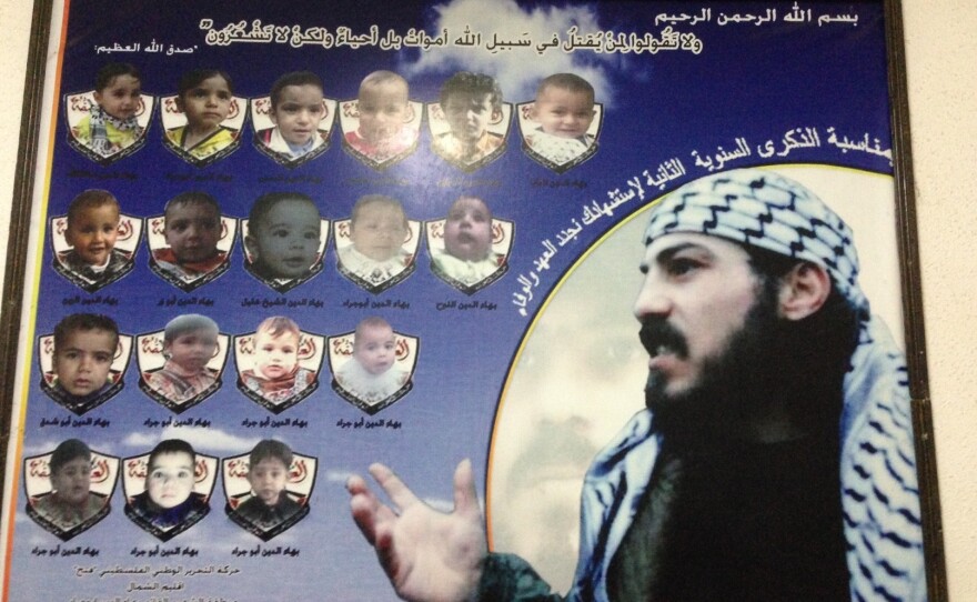A poster of Baha Abu Jarad, a member of the Fatah movement, who was killed by the rival Hamas faction, according to his family. The small photos show children that were named after Baha.