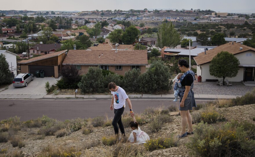 Dr. Chris Hoover (left) and Dr. Connie Liu (right) walk through their home with their children Taro, 3, and Hiro, 4 months, in Gallup, N.M. On a short reporting trip across the Southwest, NPR met very different families and asked them the same simple question: What's been keeping you at night?