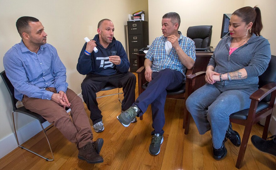 From left to right: Felito Diaz, Julio Cesar Santiago, Richard Lopez and Irma Bermudez meet at Casa Esperanza, a treatment and transitional housing program in Roxbury, Mass.