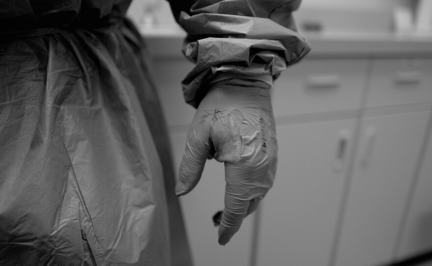 Neal's glove was shredded after a rough ride in the ambulance spent trying to control a young woman they picked up outside of her friend's apartment in May of 2020.