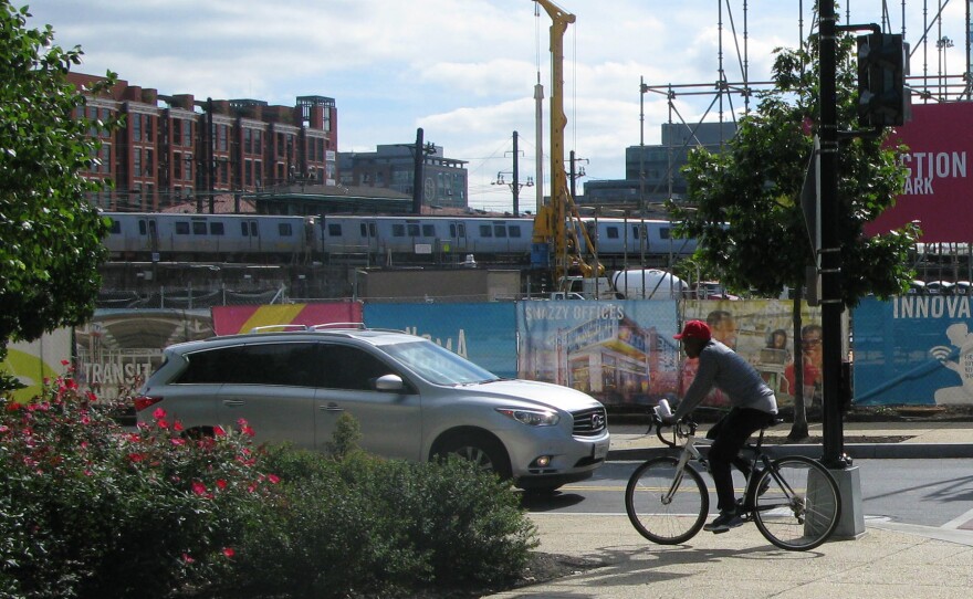 A cyclist rides on the sidewalk in the NoMa neighborhood of Washington, D.C.