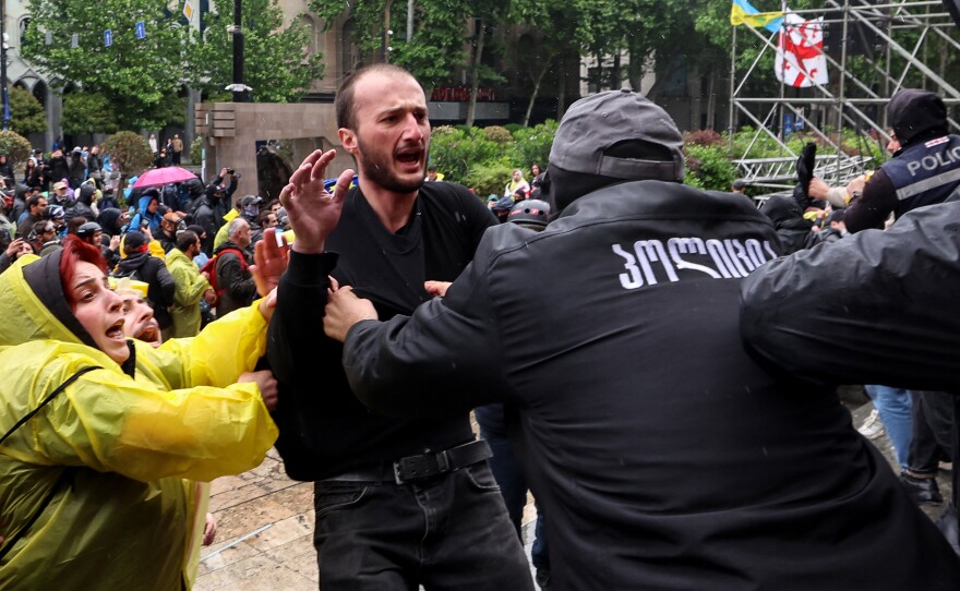 Georgian law enforcement officers detain protesters outside the parliament during a rally against the controversial "foreign influence" bill in Tbilisi on Tuesday.