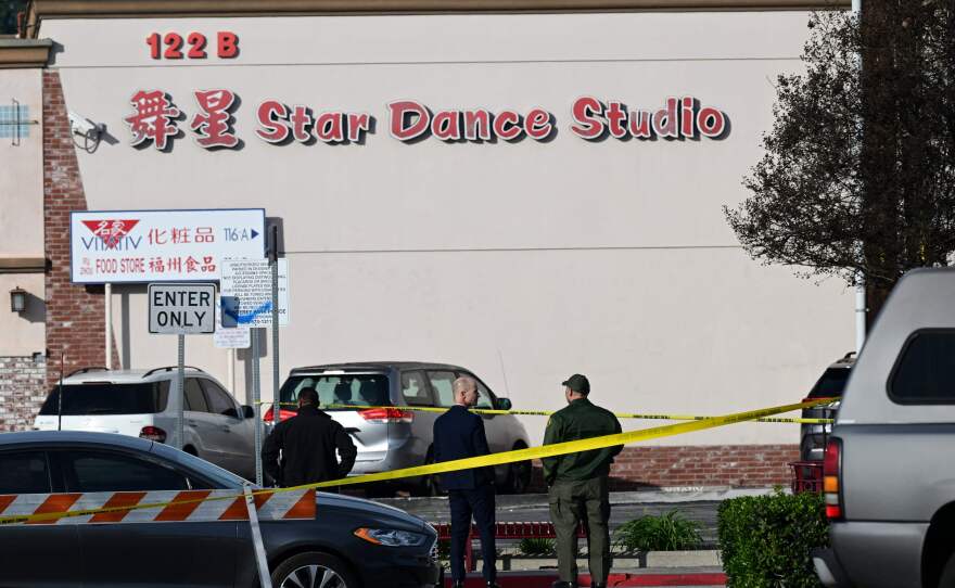 Investigators work at the scene of Saturday's mass shooting in Monterey Park, California.