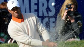 LA JOLLA, CA - JANUARY 24: Tiger Woods hits out of the bunker on the 18th hole during the first round at the Farmers Insurance Open at Torrey Pines Golf Course on January 24, 2013 in La Jolla, California.