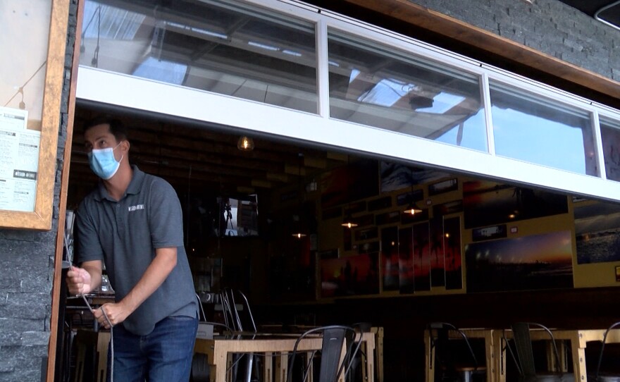 Cameron Braselton closes the patio to his Oceanside restaurant Mission Avenue Bar and Grill, June 26, 2020.