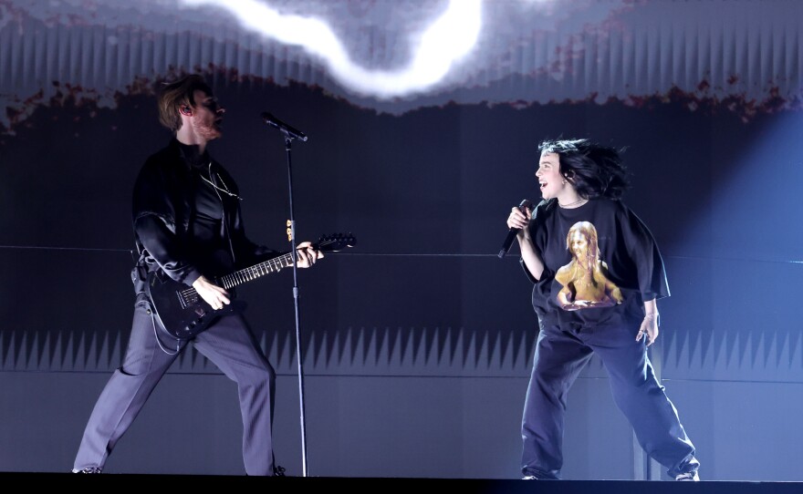 Billie Eilish (right) performs "Happier Than Ever" with her brother and collaborator FINNEAS at the 64th annual Grammy Awards in Las Vegas. Eilish, who was nominated for seven awards but won none, wore a t-shirt with an image of Foo Fighters drummer Taylor Hawkins, who died last month.