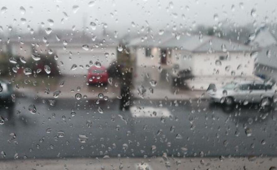 Rain is seen on a window looking out on to a street in Oak Park, Dec. 12, 2014.
