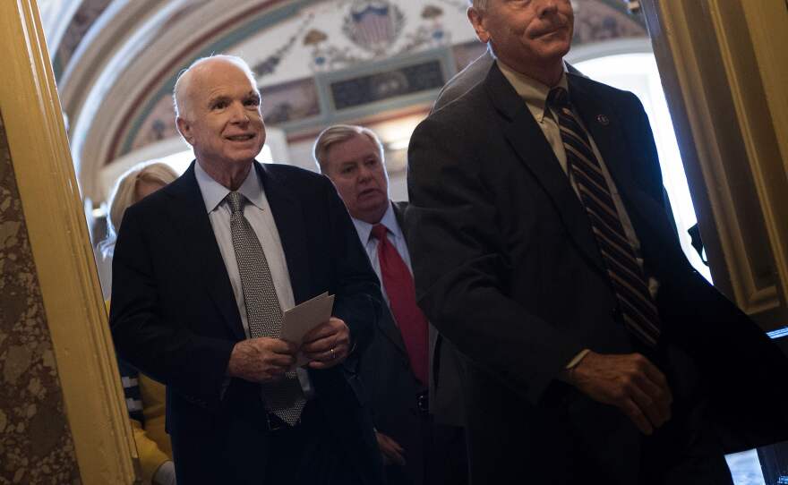 Sen. John McCain, R-Ariz., leaves after a procedural vote on health care on Capitol Hill on Tuesday. McCain also addressed his colleagues on the floor.