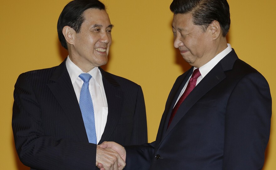 Chinese President Xi Jinping, right, and Taiwanese President Ma Ying-jeou, left, shake hands at the start of a historic meeting. The moment marks the first top-level contact between the formerly-bitter Cold War foes in 66 years.