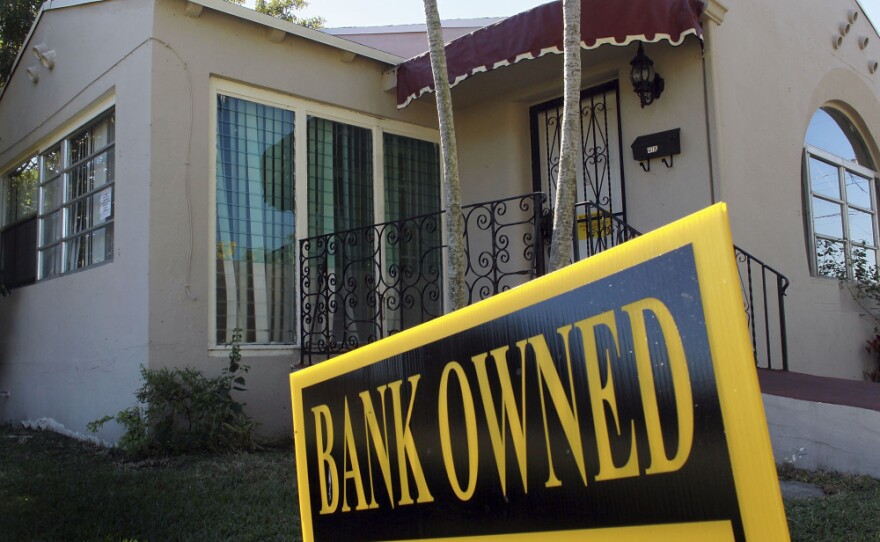 <p>A bank-owned sign is seen in front of a foreclosed home in Miami. Florida was among the hardest hit states in the real estate collapse.</p>