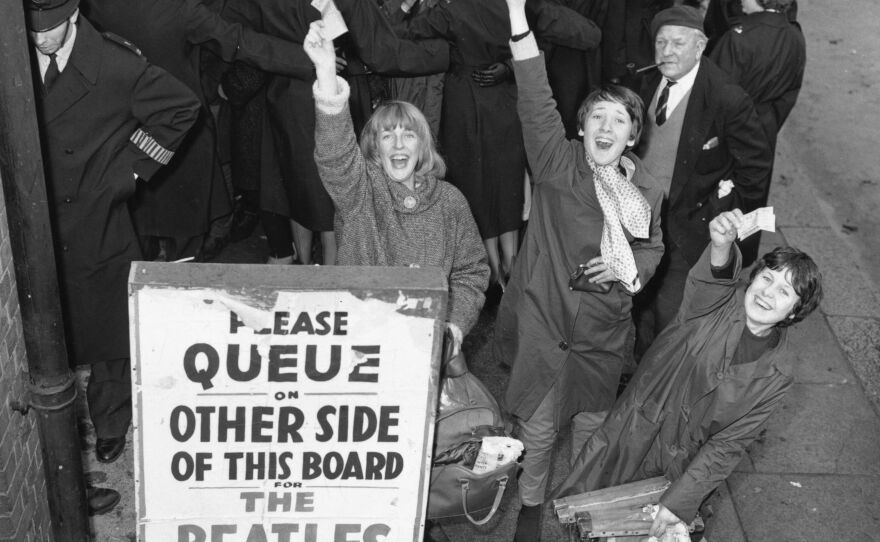 Fans in London hold tickets for a Beatles concert in November 1963.