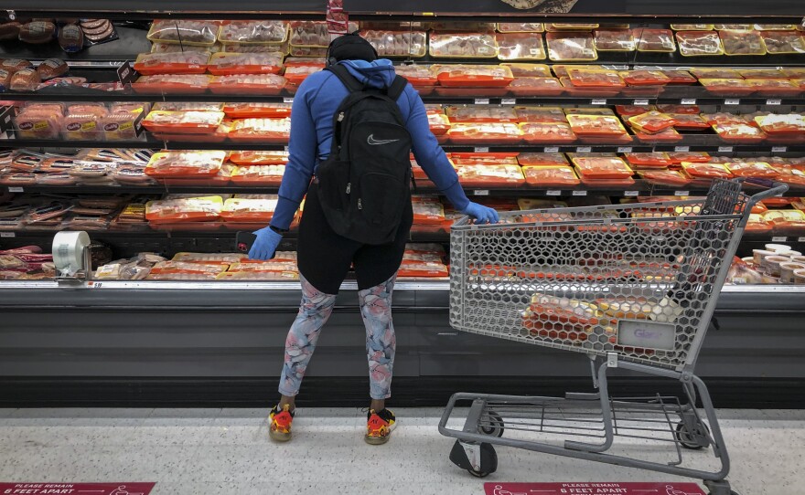 A woman shops for chicken at a grocery store in Washington, D.C., in April 2020.