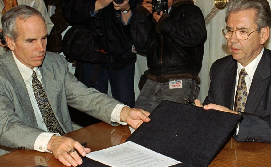 Douglas Tompkins (left) and Juan Villarzu, chief of staff of the Chilean president, with the text of a 1997 agreement permitting the development of a huge nature sanctuary in southern Chile.