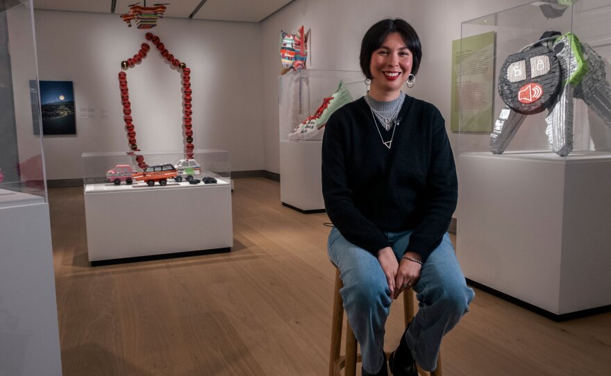 Artist Diana Benavídez is shown with several of her piñata sculptures at Mingei International Museum in an Apr. 10, 2023 photo.