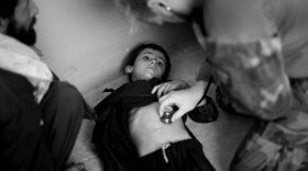 A U.S. Special Forces medic treats a young Afghan boy in May in the Zirko Valley of western Afghanistan.