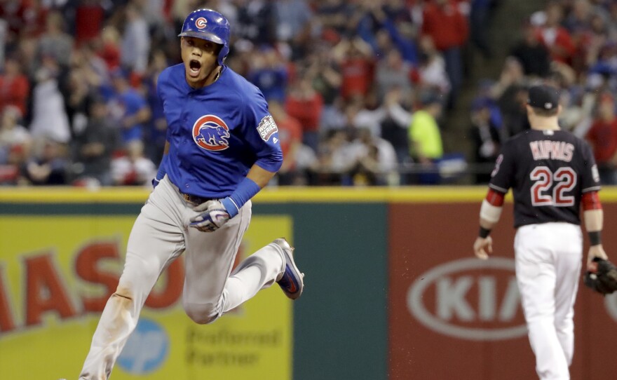 The Chicago Cubs' Addison Russell celebrates after his grand slam against the Cleveland Indians during the third inning of Game 6 of the World Series Tuesday in Cleveland.