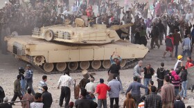 An army tank keeps Supporters of President Mubarak (top) separate from anti-government protestors in Tahrir Square on February 3, 2011 in Cairo, Egypt. The Army have positioned tanks between protesters who had been battling with supporters of President Hosni Mubarak for the second day in and around Tahrir Square in Cairo.