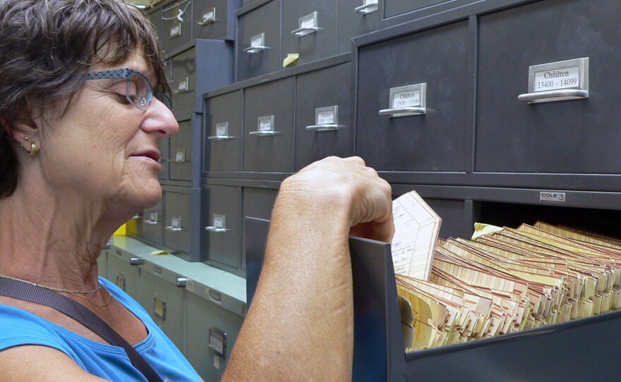 Barbara Cohn, director of the Child Health and Development Studies, looks through participant files collected over 56 years.