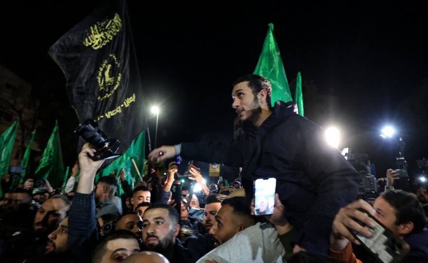 Newly released Palestinian prisoners are surrounded by supporters in Ramallah in the occupied West Bank early Thursday.